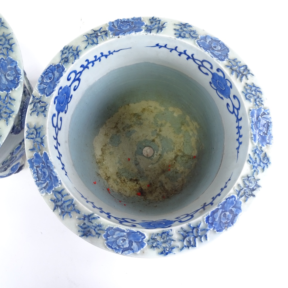 A pair of Japanese Meiji period blue and white porcelain jardinieres, with relief flower panels - Image 10 of 13