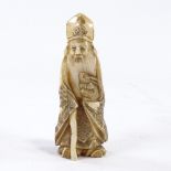 A carved ivory okimono, Sage figure with hare, height 11cm. Ink figures on base possibly from