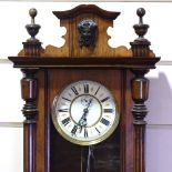 A 19th century walnut-cased Vienna regulator wall clock, with turned and fluted columns, enamel dial