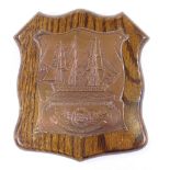 An Edwardian ship's copper commemorative plaque, for Nelson's flagship HMS Victory, on oak shield,