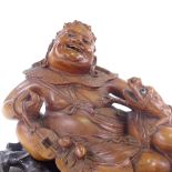 A 19th century carved wood Chinese deity with toad, probably God of wealth and good fortune, on