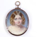 A 19th century portrait minature of a girl, watercolour on ivory, in a hinged white metal oval