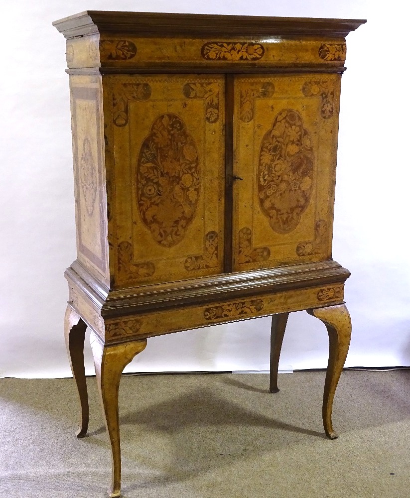 A William and Mary style walnut and marquetry inlaid cabinet on stand, enclosing drawers and central