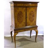 A William and Mary style walnut and marquetry inlaid cabinet on stand, enclosing drawers and central