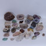A collection of various rock specimens and geodes, including watermelon tourmaline, banded agate,
