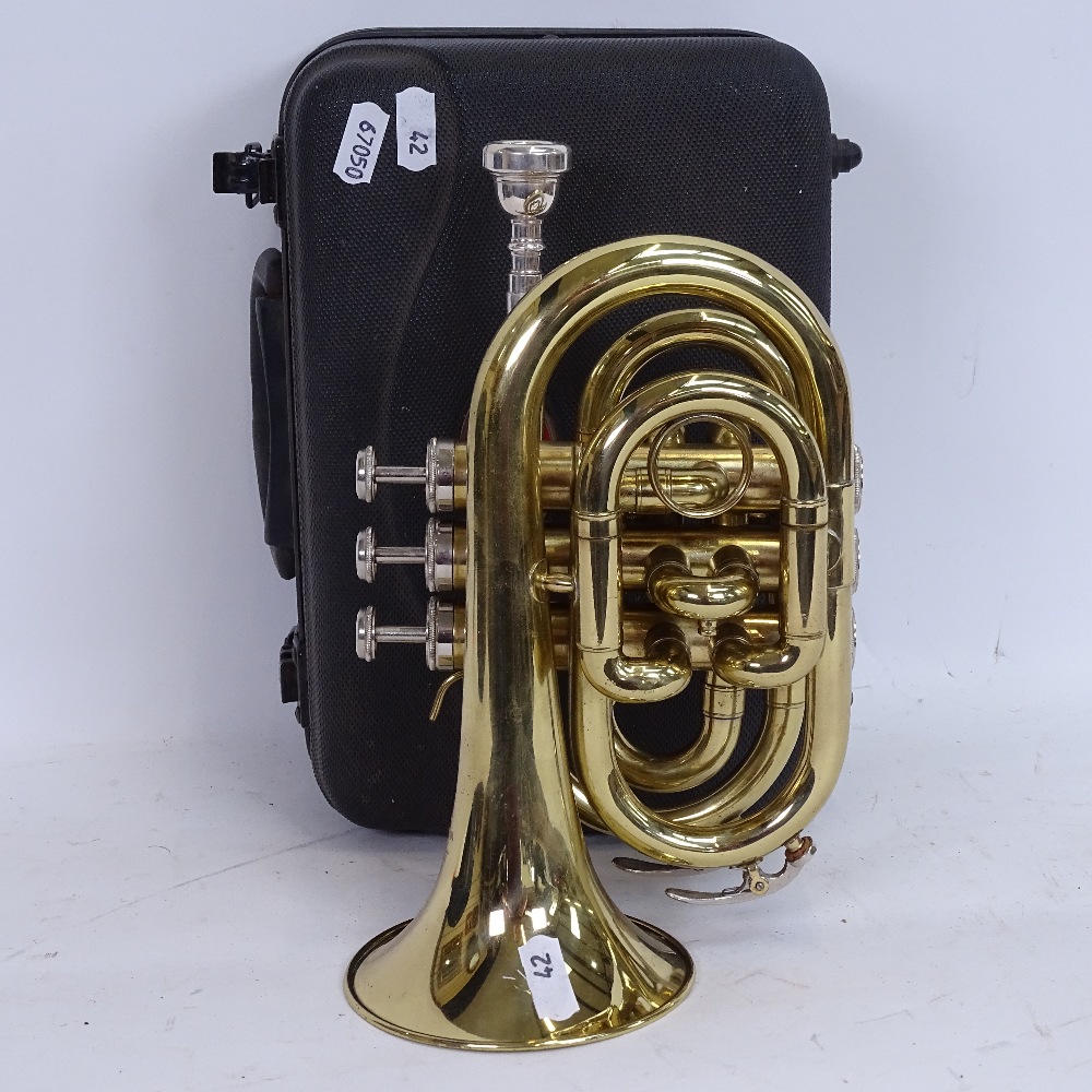 A Stagg 77-MT gold lacquered 3-valve pocket trumpet, serial no. 3419, length 24cm, in original Stagg