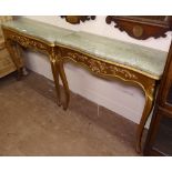 A pair of Continental giltwood console tables, of serpentine form, with shaped marble tops,