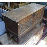 An 18th century joined oak coffer of small size, with chipped carved panelled front, on stile