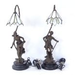 After Auguste Moreau, a pair of figural resin table lamps with Tiffany style leadlight glass shades,