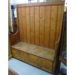 A 19th century panelled pine settle, the seat fitted with 3 drawers, W140cm, H170cm, D45cm