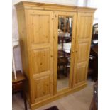 A modern polished and panelled pine 3-door wardrobe, W156cm