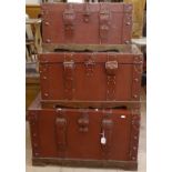 A graduated set of 3 studded leather-upholstered trunks