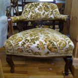 A Victorian upholstered bow armchair, on cabriole legs