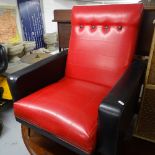 A mid-century black and red rexine-upholstered armchair