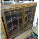 A 1920s walnut bookcase with 2 lattice glazed doors, W97cm