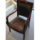 An Empire style mahogany open-arm desk chair, with studded leather upholstery