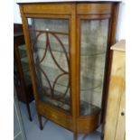 A fine quality late Victorian mahogany and satinwood-strung display cabinet, with glazed bow ends,