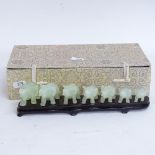A modern set of carved and polished jade elephants, on fitted display stand with original box