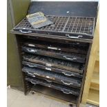 A Vintage painted metal printer's cabinet, complete with 10 printer's trays, and a large quantity of
