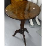 An 18th century oak tripod table with circular tilt-top, W54cm