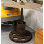 An unusual cast-iron garden table with circular saw top, H67cm