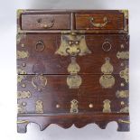 An Oriental stained hardwood table-top chest of drawers, brass fittings, height 40cm