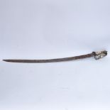 An Indian brass-handled lion pommel curved sword, blade length 76cm