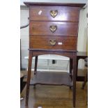 An Arts and Crafts oak smoker's stand, with the dummy drawer front revealing a shelf and drawer