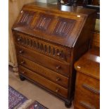 A 1930s oak bureau, with linenfold panelled front and 4 long drawers under, on bun feet, W77cm