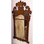 A Georgian walnut wall mirror, with shaped top and applied gilded floral decoration, L85cm