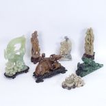 A collection of various Oriental soapstone and jadeite carvings, including water buffalo, and