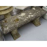 A weathered rectangular concrete garden bench, L117cm