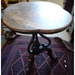 A Victorian rosewood lamp table, with shaped oval top, on cabriole legs