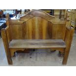 An Antique walnut hall bench, with raised shaped back, W127cm
