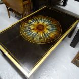 A modern brass-framed glass-top coffee table, with inset compass decoration, L102cm