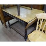 A 1920s oak rectangular drop leaf table, with Archadian carved frieze, raised on baluster legs,