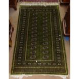A green ground Tekke design wool rug, 160cm x 97cm