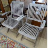 A pair of weathered hardwood folding garden chairs