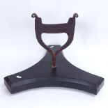 A 19th century cast-iron boot scraper, on large later black marble tri-form base, overall height