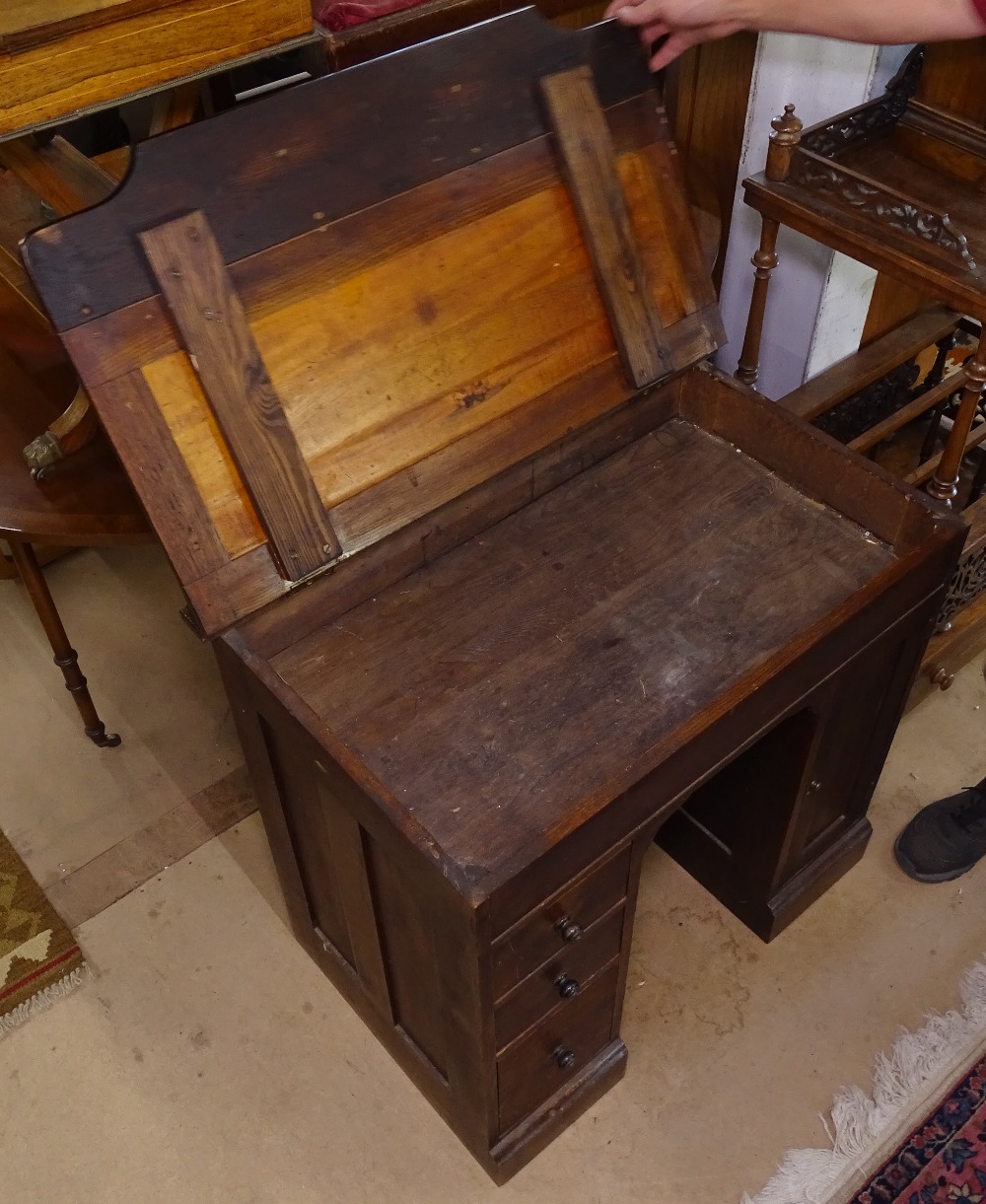 A 1920s oak writing desk of small size, with rising lid, fitted drawers and cupboard, W80cm - Image 2 of 2
