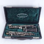 A Vintage Louis of London ebony clarinet, in fitted hardshell Howarth case (lacking one piece)