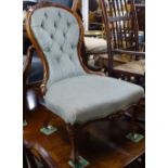 A Victorian walnut-framed and button-back upholstered nursing chair