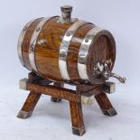 A small oak table-top Whisky barrel dispenser, electroplate mounts with original cork, barrel length