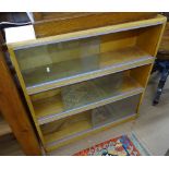 A mid-century light oak 3-section bookcase, with sliding glass doors, W91cm
