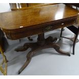 A Regency mahogany fold over card table, on a spiral and carved turned centre column, sabre leg