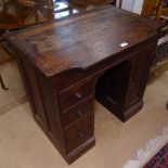 A 1920s oak writing desk of small size, with rising lid, fitted drawers and cupboard, W80cm