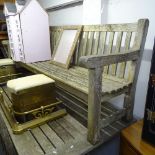 A large weathered hardwood slatted garden bench, L231cm