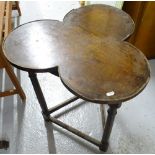 An Antique oak cricket table, with a later clover leaf design top, W60cm