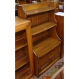 An Ercol Chaucer waterfall open bookcase, with cupboard to the base, W61cm