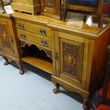 An Art Nouveau mahogany break-front sideboard, fitted with drawers and cupboards and stylised